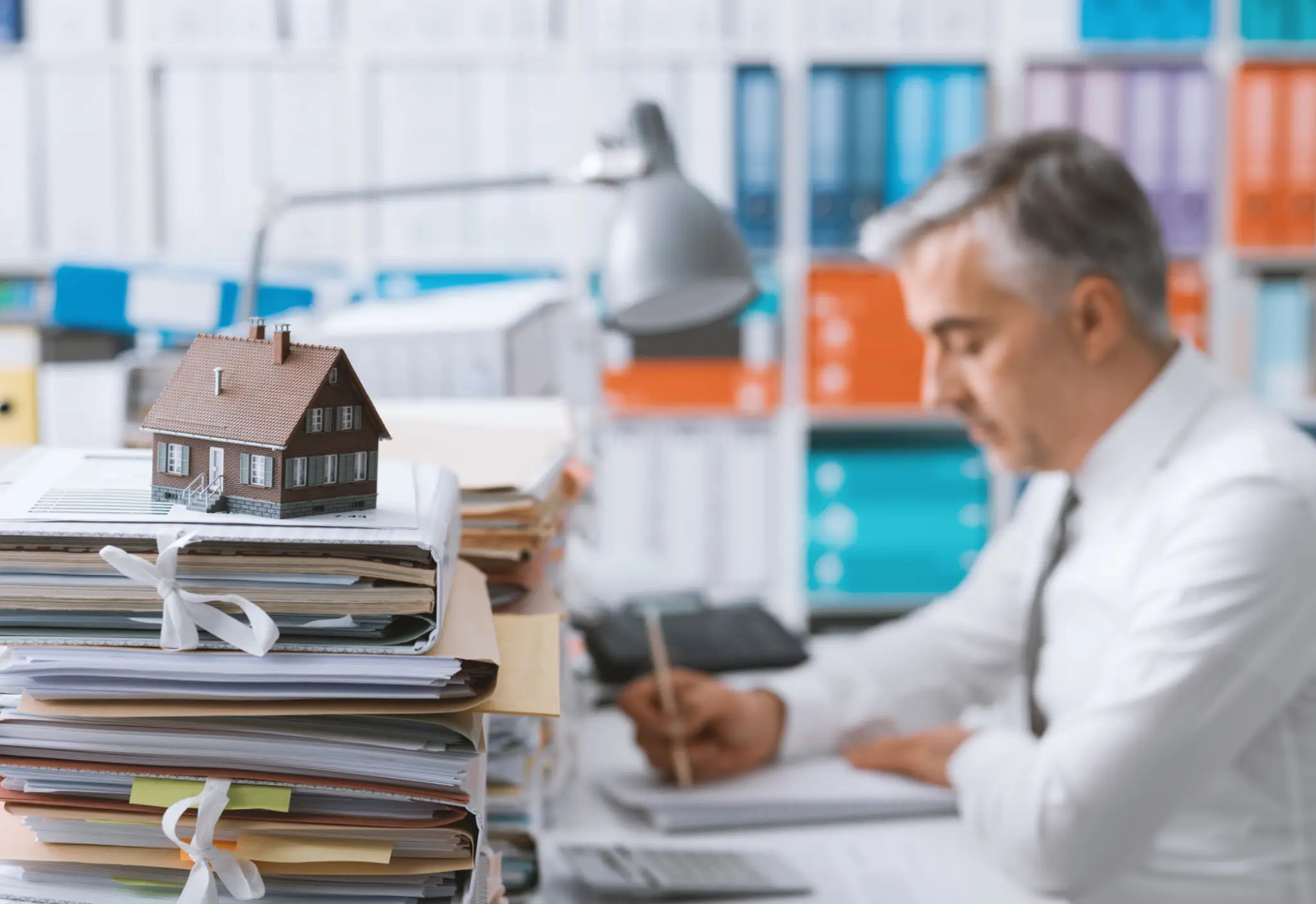 Bank analyst extracting financial data for loan spreading